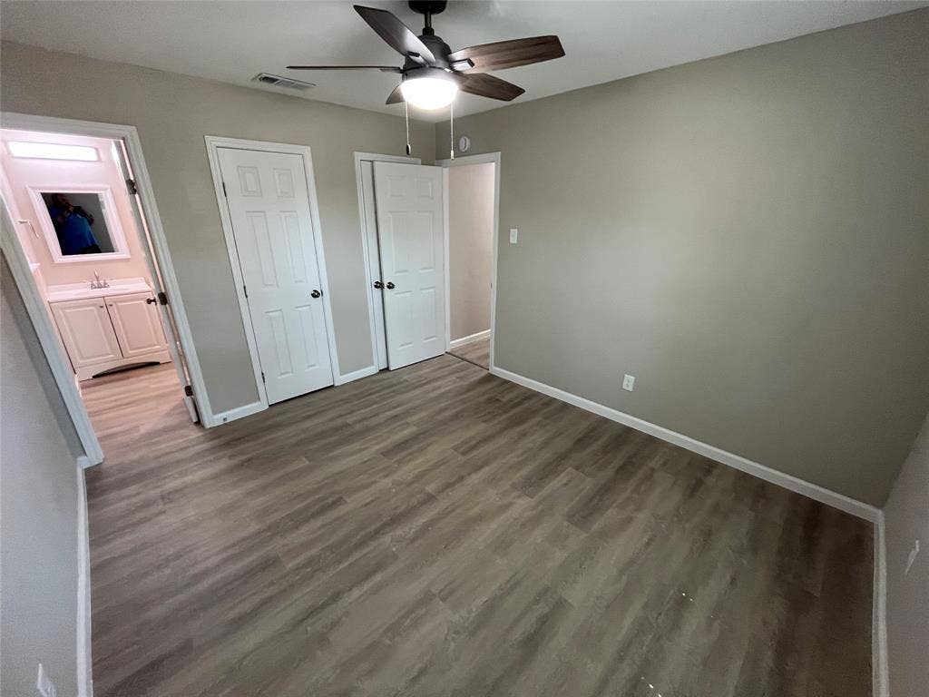 9615 Oak Gate Lane, Dallas, TX 75217 Wood-finish flooring throughout, neutral wall tones, and overhead ceiling fan with lighting
