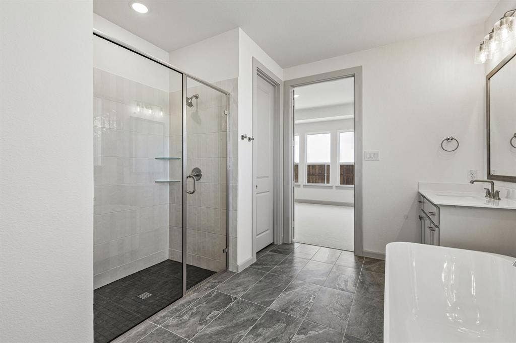 1825 Vetiver Glow Drive, Celina, TX 75009 Whether it's soaking your cares away in the freestanding tub or indulging in a long, luxurious shower, you'll enjoy a spa like experience every day in this wonderful owner's bath!