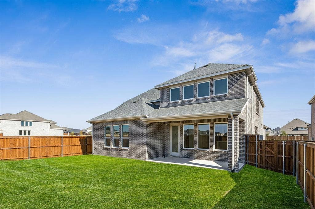 1825 Vetiver Glow Drive, Celina, TX 75009 Plenty of summertime fun to be had by all in this wonderful fenced backyard with covered back patio!