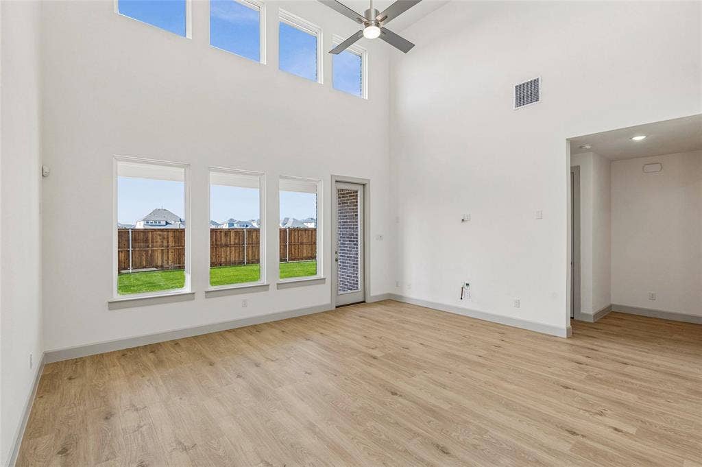 1825 Vetiver Glow Drive, Celina, TX 75009 With floor to ceiling windows, this home is flooded with natural light both upstairs and down!