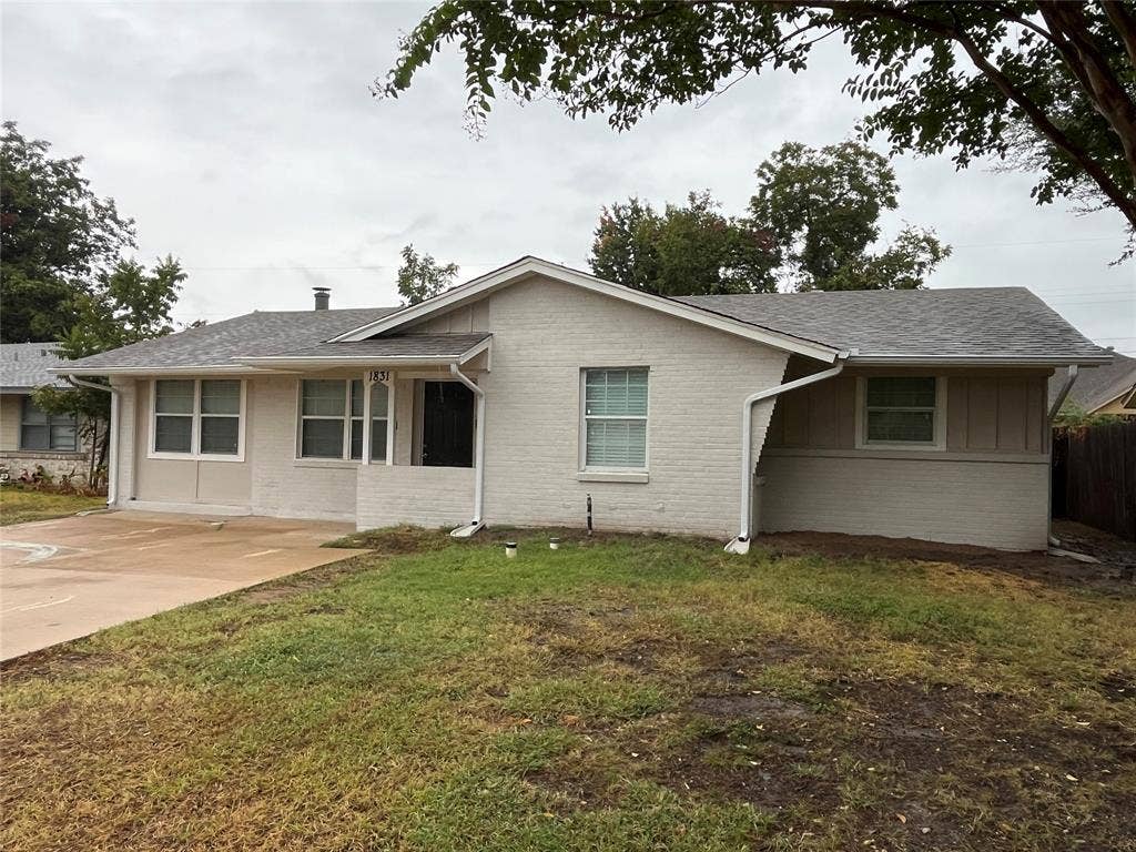 1831 Moonbeam Lane, Carrollton, TX 75006 Brick and siding exterior with a shingle roof, complemented by white window frames and a concrete driveway