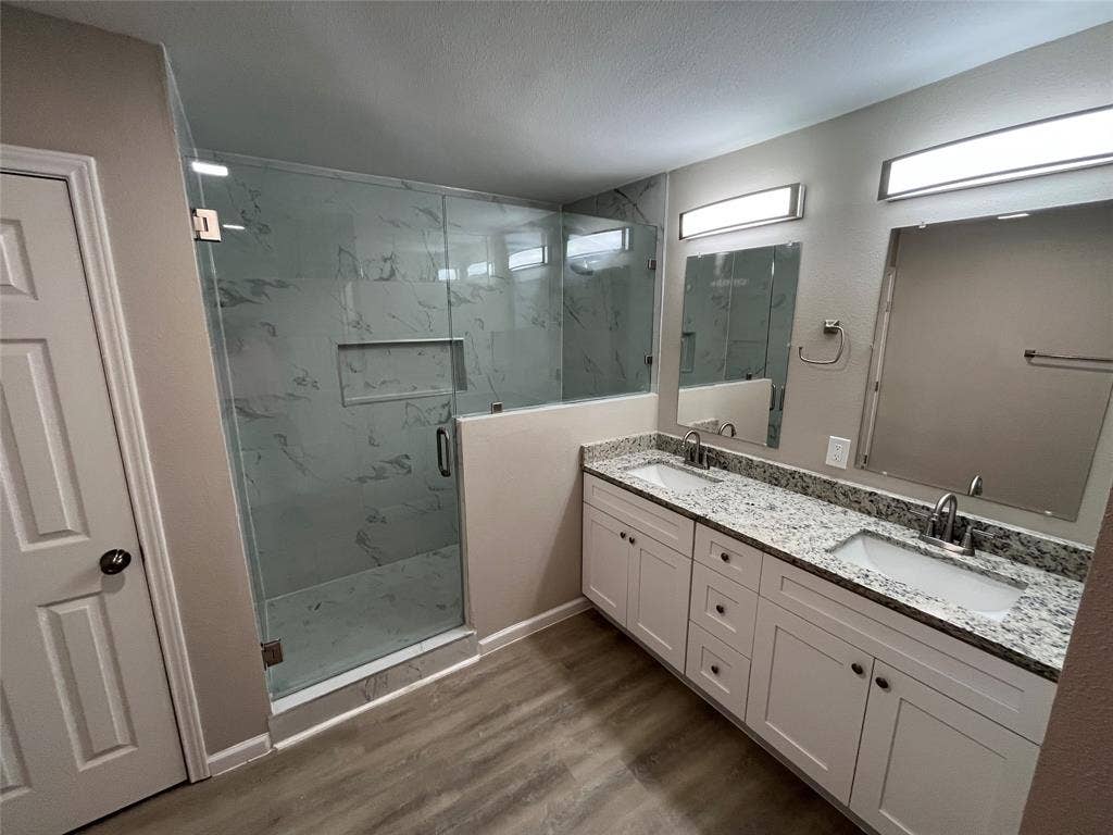 1831 Moonbeam Lane, Carrollton, TX 75006 Expansive dual vanity with stone countertops, under-mount sinks, and individual mirrors