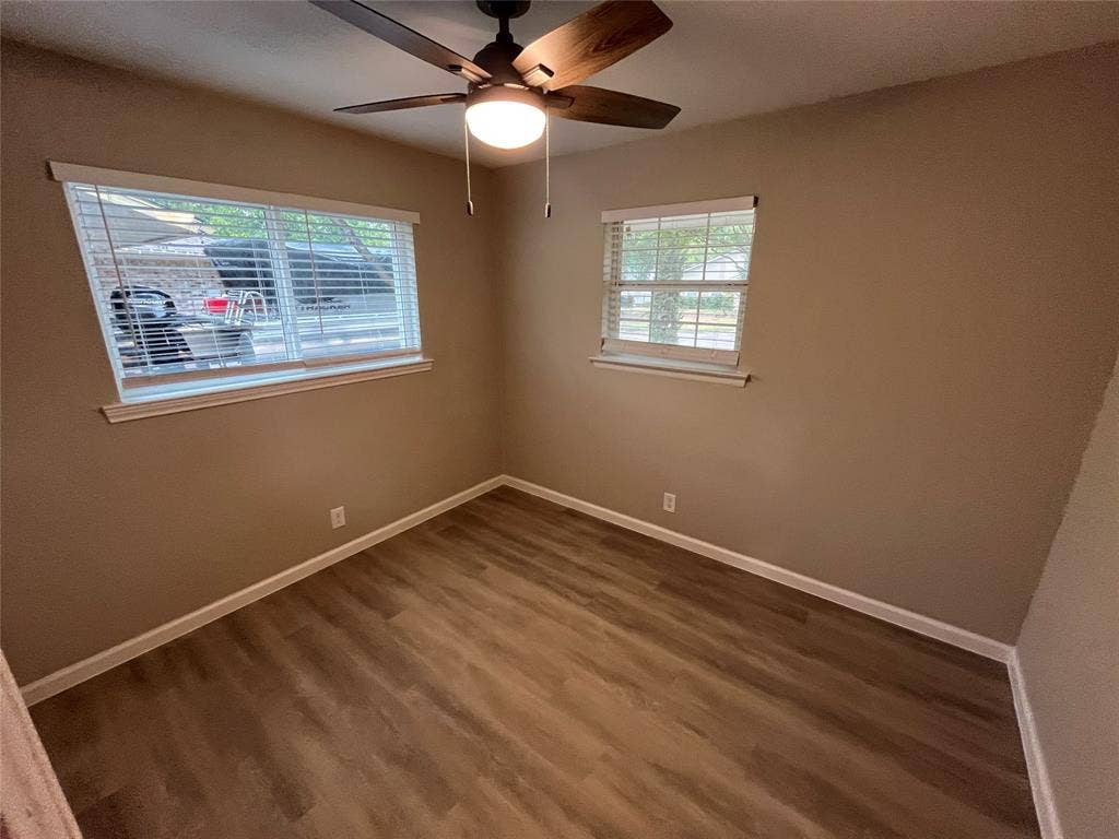 1831 Moonbeam Lane, Carrollton, TX 75006 Wood-finish flooring throughout, complemented by a ceiling fan with integrated lighting