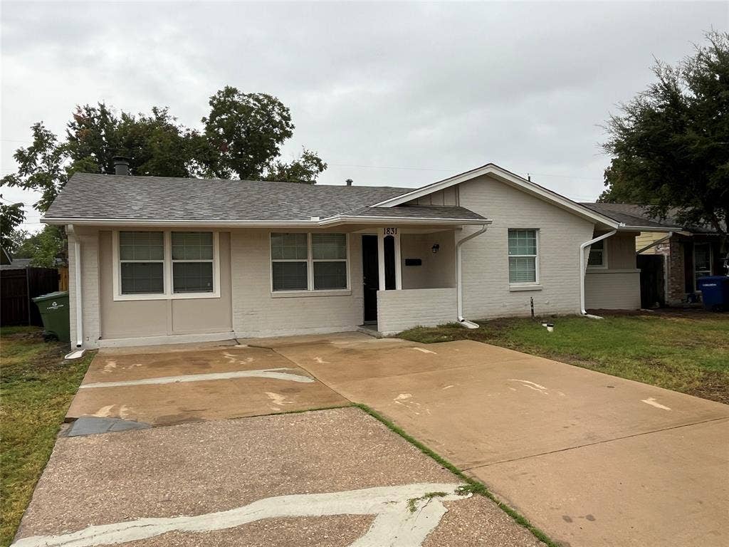 1831 Moonbeam Lane, Carrollton, TX 75006 Single-story residence featuring a painted brick exterior, covered entry, multiple windows, and a paved driveway