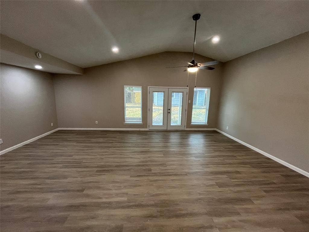 1831 Moonbeam Lane, Carrollton, TX 75006 Vaulted ceiling with a ceiling fan, recessed lighting, wood-finish flooring, and double glass-paneled doors