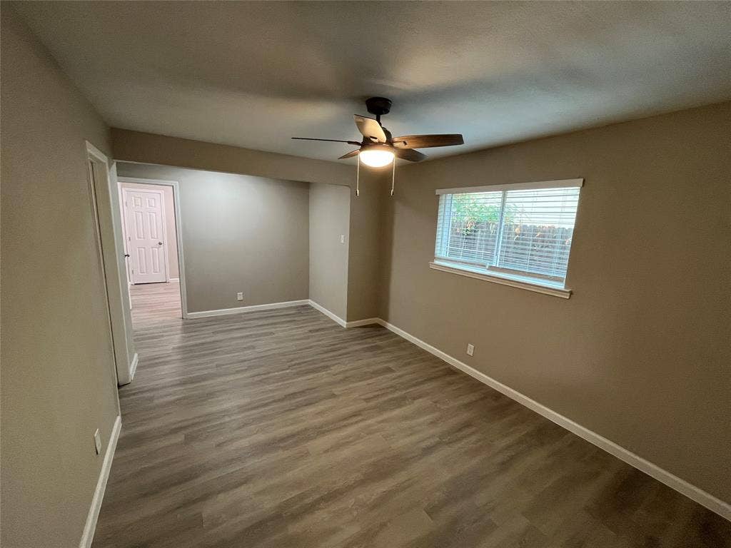 1831 Moonbeam Lane, Carrollton, TX 75006 Wood-finish flooring, ceiling fan with integrated lighting, window with blinds, neutral wall tones, and white trim