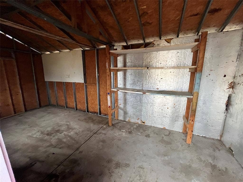 1831 Moonbeam Lane, Carrollton, TX 75006 Concrete flooring with exposed ceiling joists and wall studs