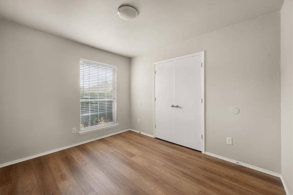 1017 Caleb Street, Burleson, TX 76028 Secondary bedroom with wood look laminate flooring