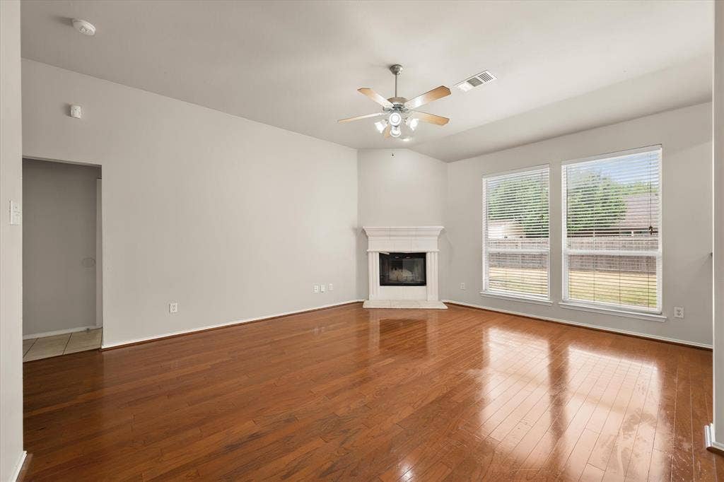 1017 Caleb Street, Burleson, TX 76028 Huge living room with wood burning fireplace and wood floors