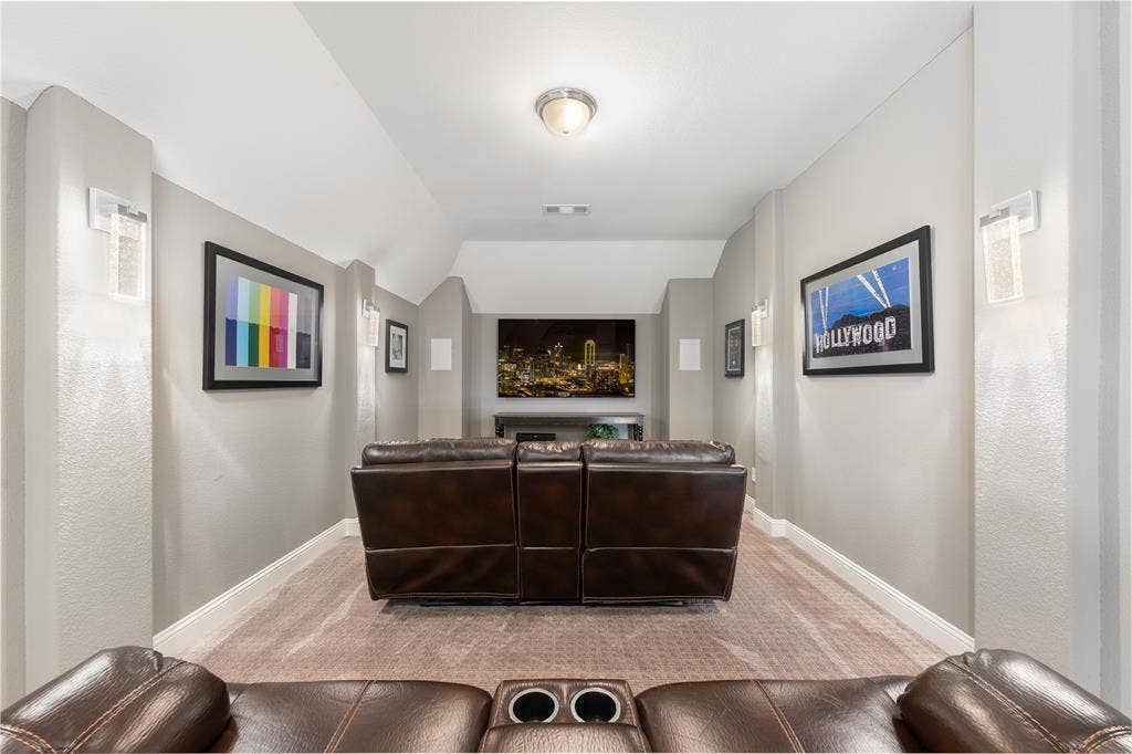 121 Lantana Lane, Wylie, TX 75098 Recessed ceiling with integrated lighting, wall-mounted sconces, mounted display screen, built-in speakers, and neutral carpeting