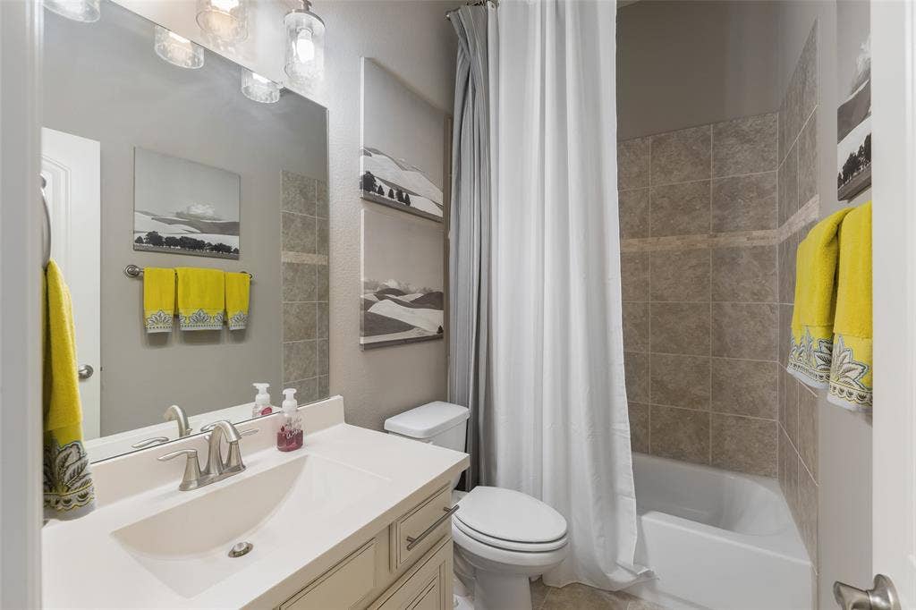 121 Lantana Lane, Wylie, TX 75098 Vanity with an integrated sink, brushed nickel faucet, and under-cabinet storage
