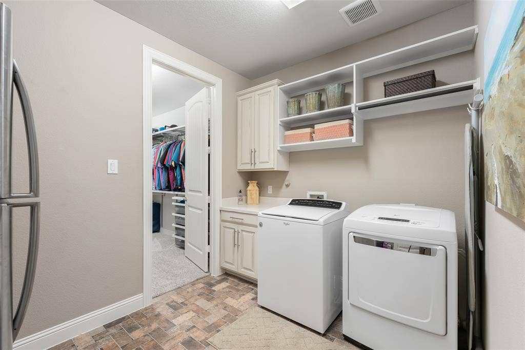 121 Lantana Lane, Wylie, TX 75098 Laundry area with permanent upper shelving, built-in cabinetry, and a countertop surface