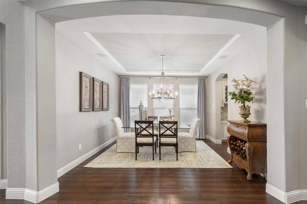 121 Lantana Lane, Wylie, TX 75098 Arched entryway leading to a room with wood-finish flooring, tray ceiling, and recessed lighting