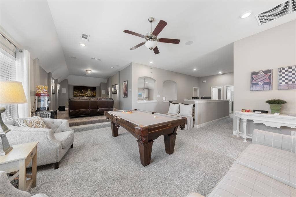 121 Lantana Lane, Wylie, TX 75098 Spacious entertainment room featuring carpeting, a tiered media area, recessed lighting, and a ceiling fan
