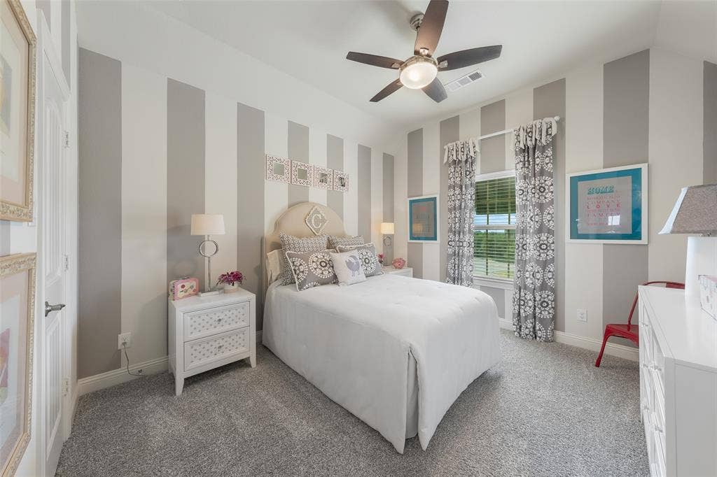121 Lantana Lane, Wylie, TX 75098 Carpeted flooring, a window with blinds, a ceiling fan with integrated lighting, and painted striped walls