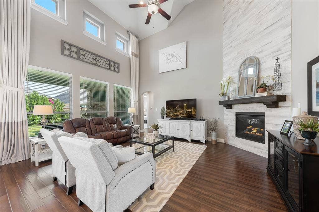 121 Lantana Lane, Wylie, TX 75098 Vaulted ceilings, wood-finish flooring, and a fireplace with a wood mantle and shiplap-style surround