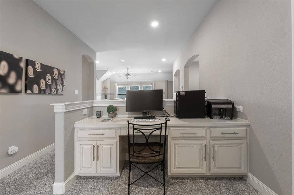 121 Lantana Lane, Wylie, TX 75098 Built-in desk with cabinet storage, recessed lighting, arched doorways, and carpeted flooring