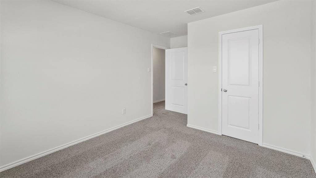 5610 Gannet Place, Crandall, TX 75114 Neutral-toned wall, two-panel interior doors, gray carpet flooring, baseboard trim, and ceiling ventilation