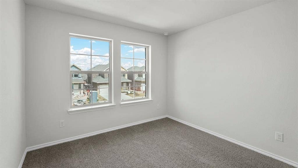 5610 Gannet Place, Crandall, TX 75114 Room featuring two large windows, neutral gray carpeting, and white baseboards