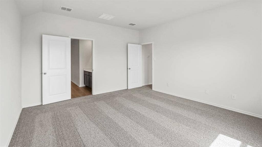 5610 Gannet Place, Crandall, TX 75114 Spacious interior room featuring light gray carpeting, neutral wall tones, white trim, and white panel doors