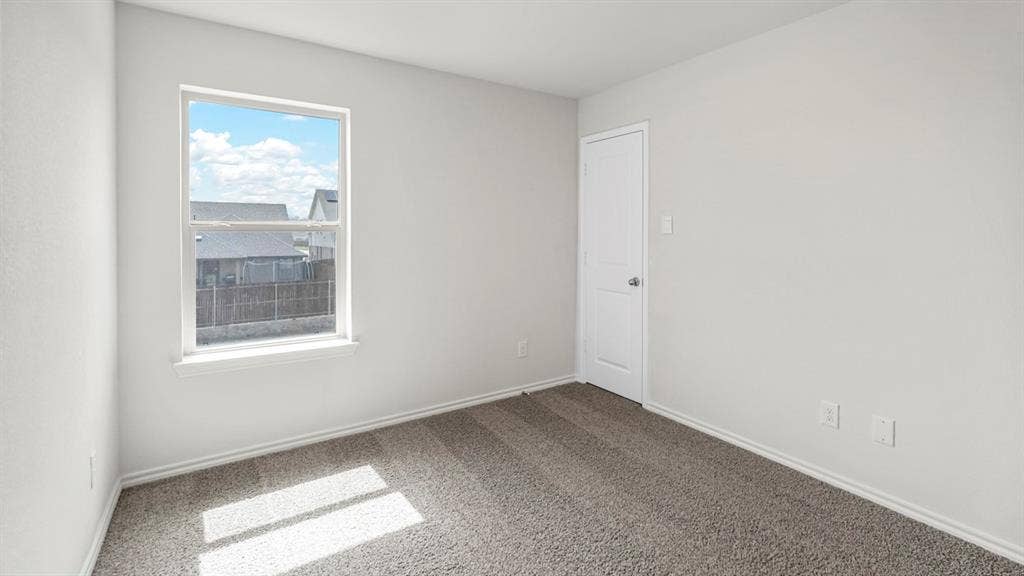 5610 Gannet Place, Crandall, TX 75114 Neutral-toned room featuring a single window, white trim, light gray wall paint, and gray carpeting