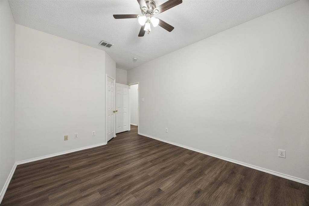 Plenty of Wall Space to Make It Your Own – This secondary bedroom offers a practical shape, good furniture placement options, and the same carpet-free flooring found throughout the home.