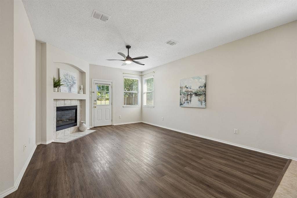 Gather Around the Fireplace – The gas fireplace creates a natural focal point in this generously sized family room, while windows near the backyard invite in light and a glimpse of the green surroundings beyond.