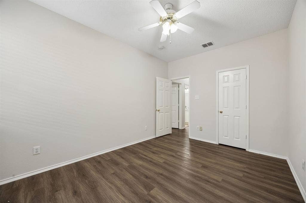 Consistent Finishes Throughout – LVP flooring, a ceiling fan, and a well-sized footprint give this secondary bedroom a cohesive look and everyday functionality.