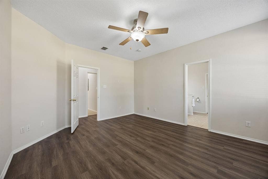 A Primary Suite with Room to Unwind – Generous dimensions give the primary bedroom plenty of flexibility for a full furniture arrangement, while LVP flooring continues the home’s carpet-free design and the ensuite bath is just steps away.