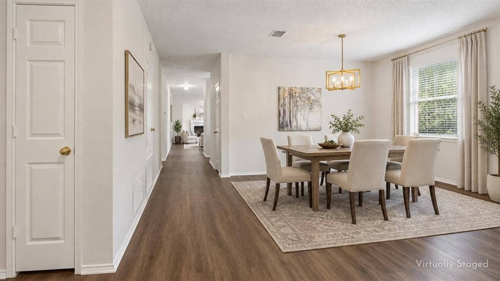 An Entry That Opens Up the Home – LVP flooring begins at the front door and continues through the main living spaces, creating an easy visual flow from the entry toward the heart of the home.