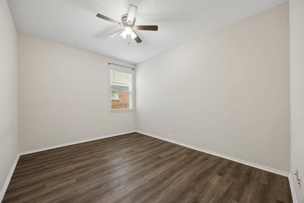 Another Spacious Secondary Bedroom – LVP flooring and a ceiling fan continue here, with a roomy layout that accommodates more than just the basics.