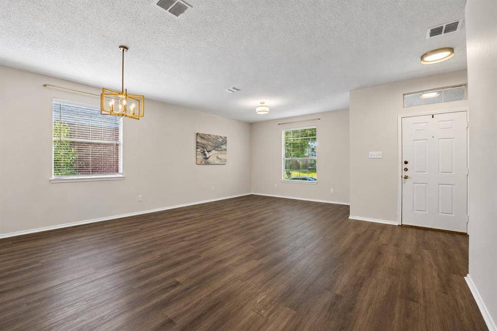 Two Gathering Spaces, One Cohesive Look – The front living and formal dining areas offer an open connection, updated lighting, and continuous LVP flooring that gives the spaces a clean, coordinated feel.