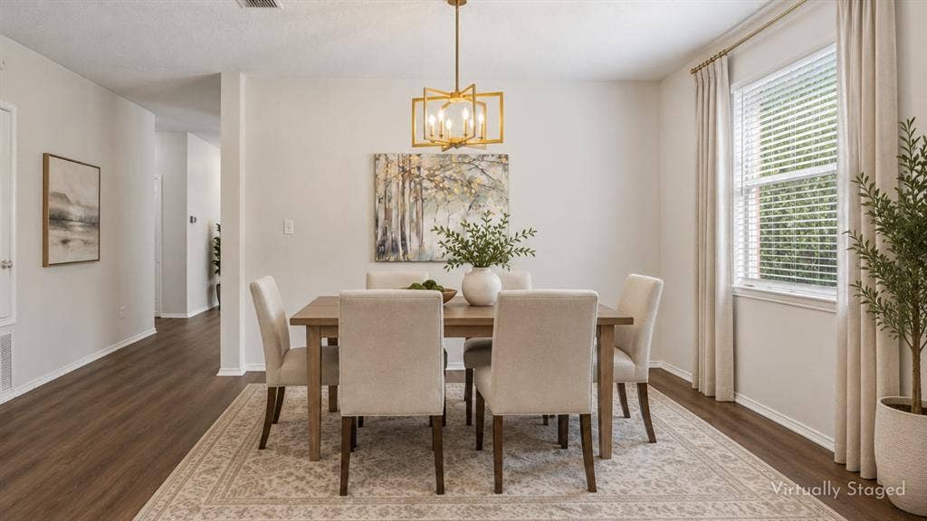 A Dining Room Ready for More Than Dinner – The dedicated formal dining area offers generous wall space, a large window for natural light, and updated lighting overhead, making it equally suited for dinner parties, celebrations, or game nights.