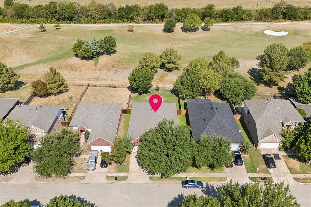 A Backyard Positioned for the View – From above, you can see how the home sits directly against the golf course, creating an open rear setting with mature trees and no immediate backyard neighbor beyond the fairway.