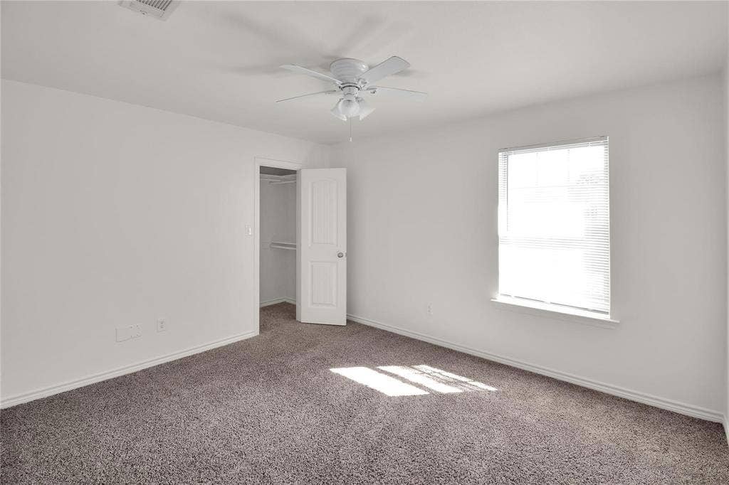 1102 Parkway Trail, Princeton, TX 75407 Neutral-toned carpeting complements the white walls