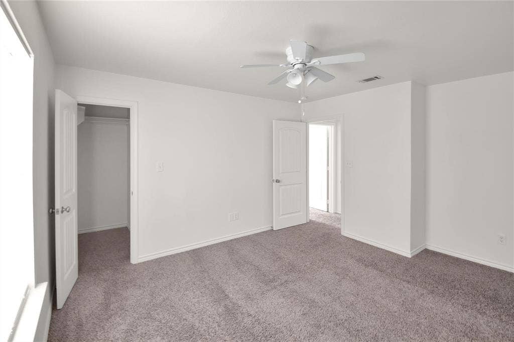 1102 Parkway Trail, Princeton, TX 75407 Neutral tone walls, grey carpet flooring, white trim, and a ceiling fan with integrated lighting
