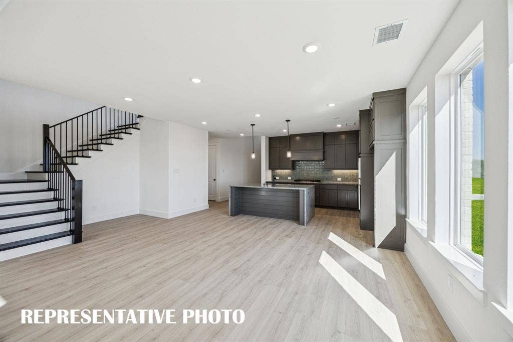 1809 Vetiver Glow Drive, Celina, TX 75009 Featuring a view to the outdoors through a wall of windows, this dining room is the perfect setting for lively dinner parties or cozy family meals! REPRESENTATIVE PHOTO