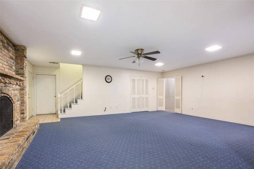 635 Sherrill Boulevard, Duncanville, TX 75116 Exposed brick fireplace with a hearth, recessed ceiling lighting, a ceiling fan, and carpeted flooring