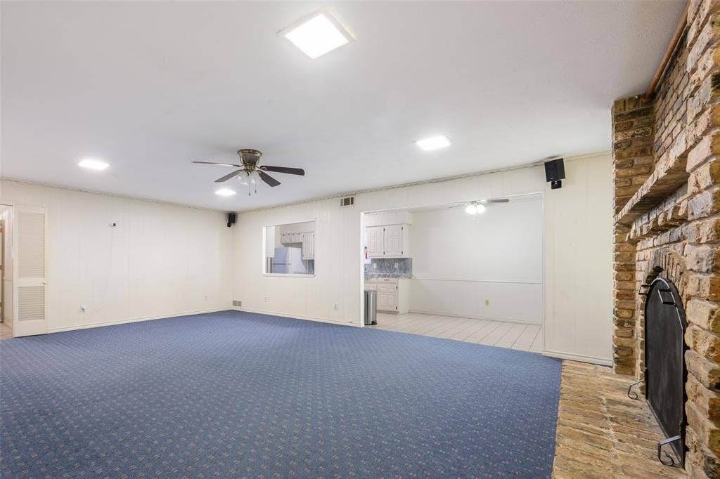 635 Sherrill Boulevard, Duncanville, TX 75116 Spacious living area featuring a brick fireplace, ceiling fan, and recessed lighting