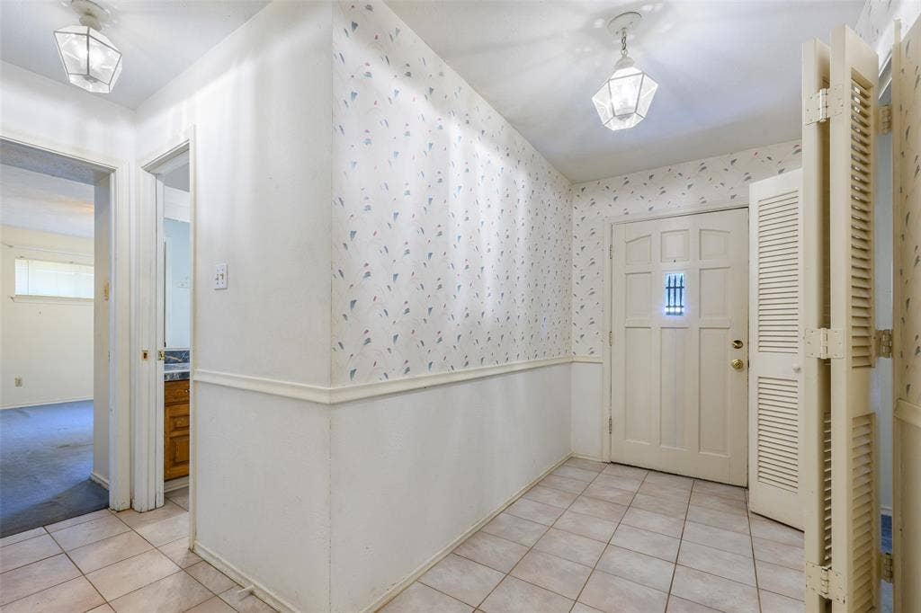 635 Sherrill Boulevard, Duncanville, TX 75116 Tile flooring in the entry, decorative front door, and wall-mounted lighting fixtures