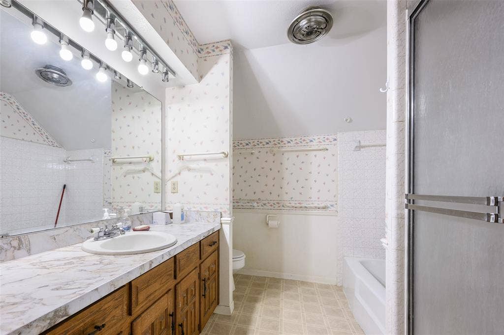 635 Sherrill Boulevard, Duncanville, TX 75116 Vanity with a single basin sink, laminate countertop, and wood-finish cabinetry