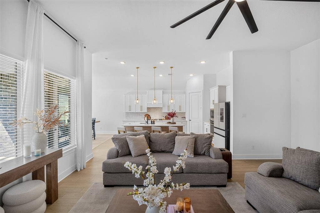 High ceilings, recessed lighting, and wood-finish flooring