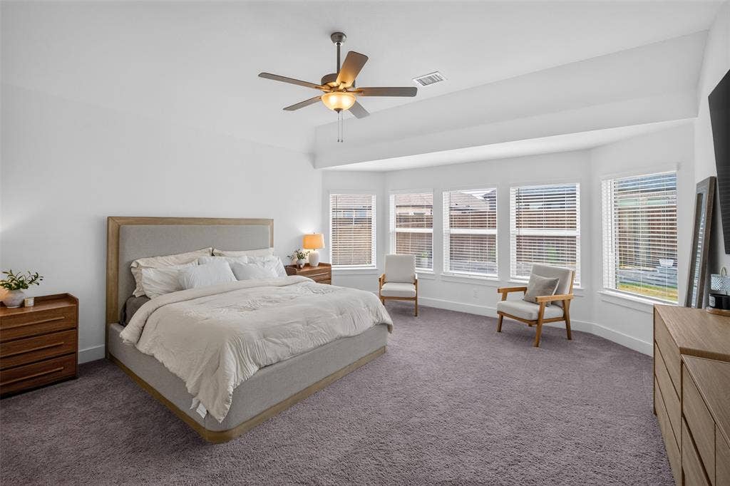 Expansive room with vaulted ceilings and a ceiling fan