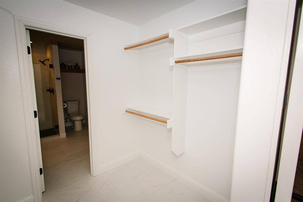 104 S Hawthorne Street, Granbury, TX 76048 Custom closet system featuring built-in shelving and hanging rods