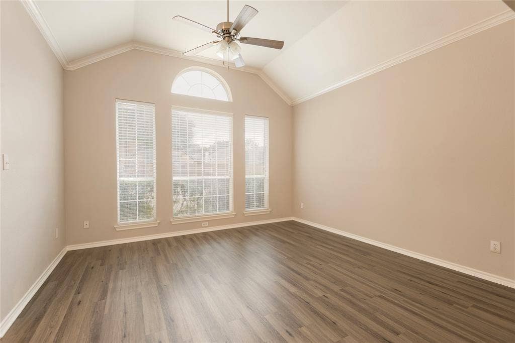 7829 Case Drive, Plano, TX 75025 Spare room with lofted ceiling, crown molding, and dark wood-type flooring