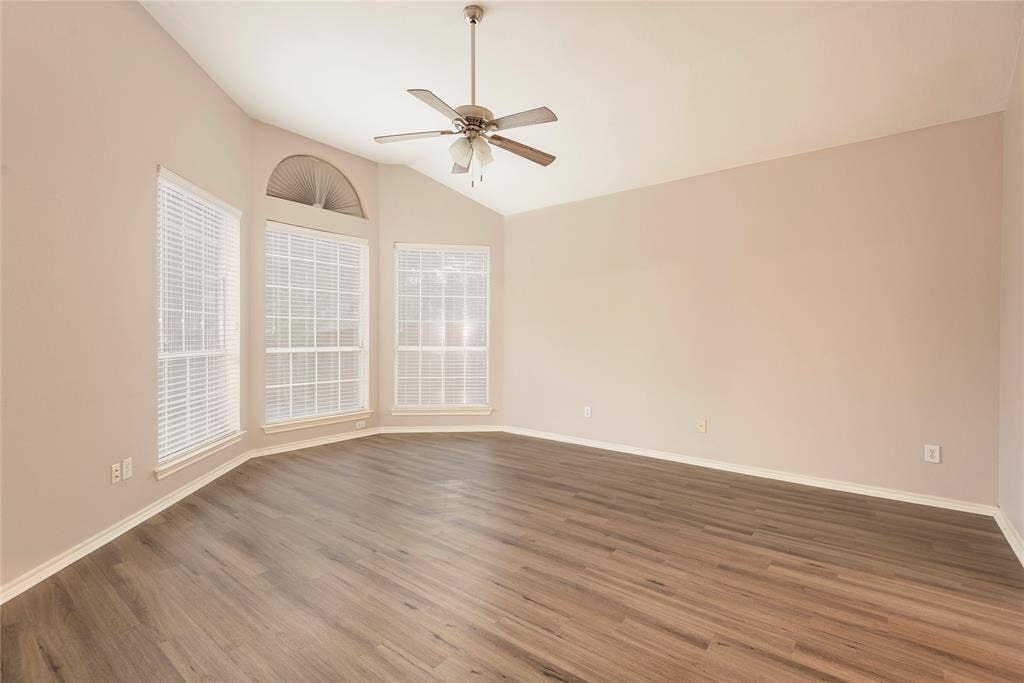 7829 Case Drive, Plano, TX 75025 Spare room featuring ceiling fan, dark wood-type flooring, and vaulted ceiling