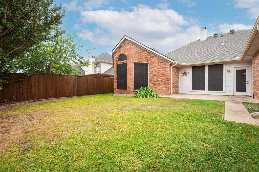 7829 Case Drive, Plano, TX 75025 Rear view of house with a lawn and a patio
