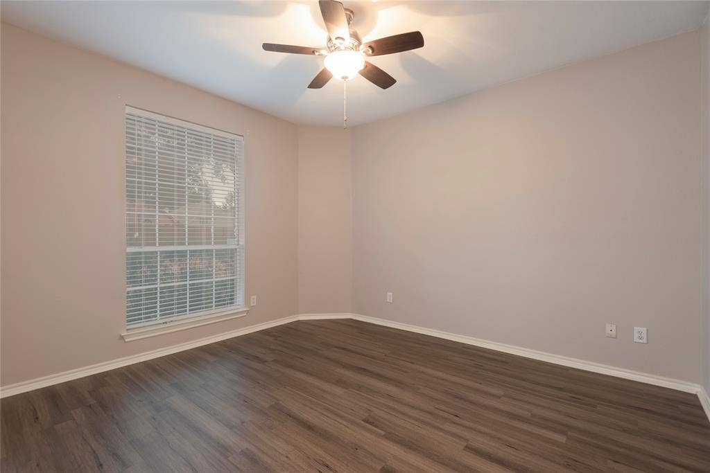 7829 Case Drive, Plano, TX 75025 Unfurnished room featuring ceiling fan and dark wood-type flooring