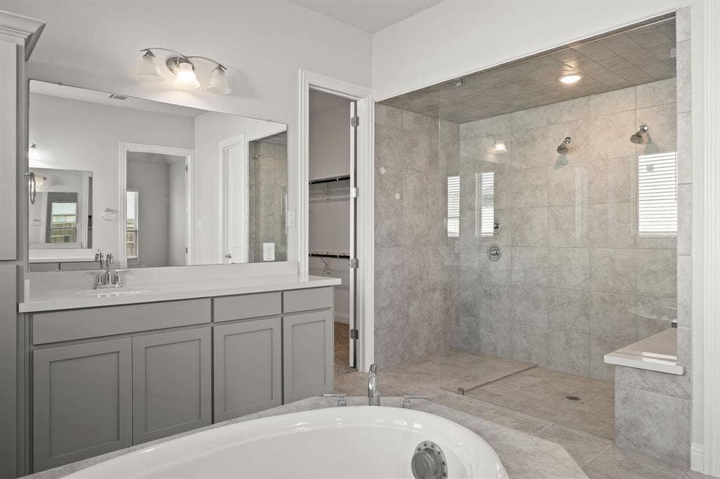 Expansive walk-in shower with dual shower heads, tiled walls, and a built-in bench