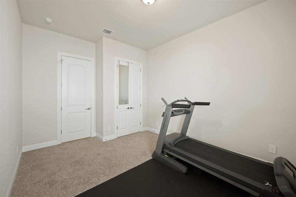Light-colored carpeting with matching wall finishes
